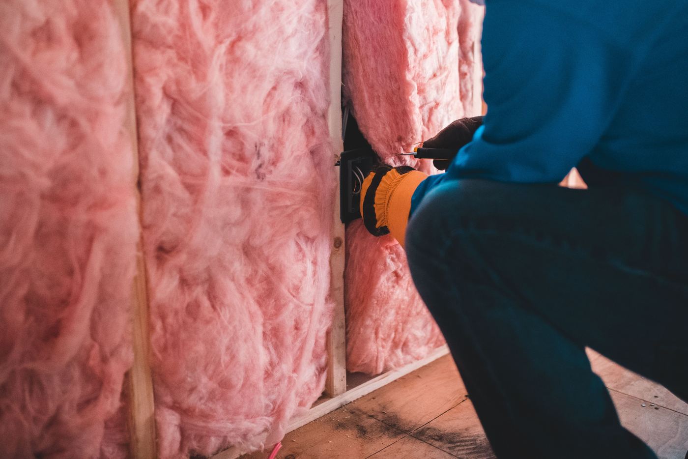 Fiberglass batt insulation fitted between wall studs