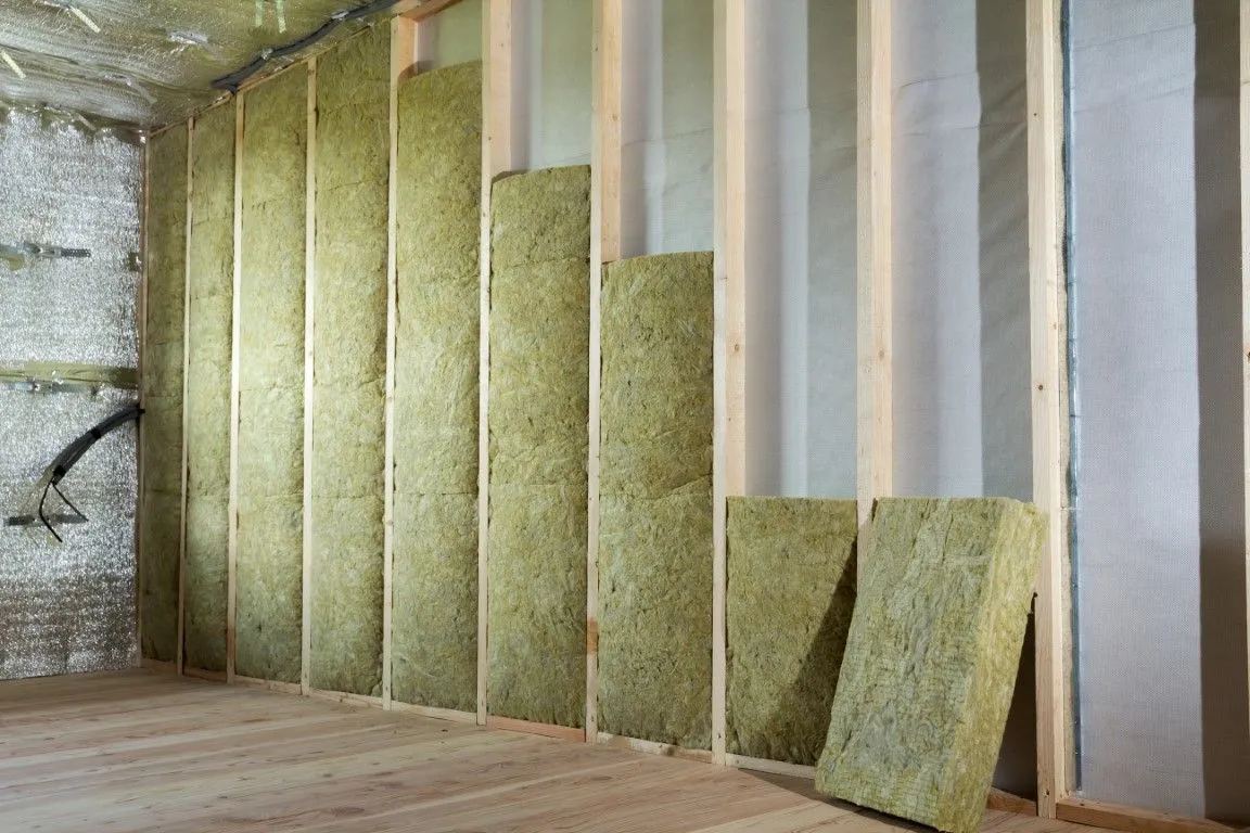 Mineral wool batt insulation fitted in a wall cavity