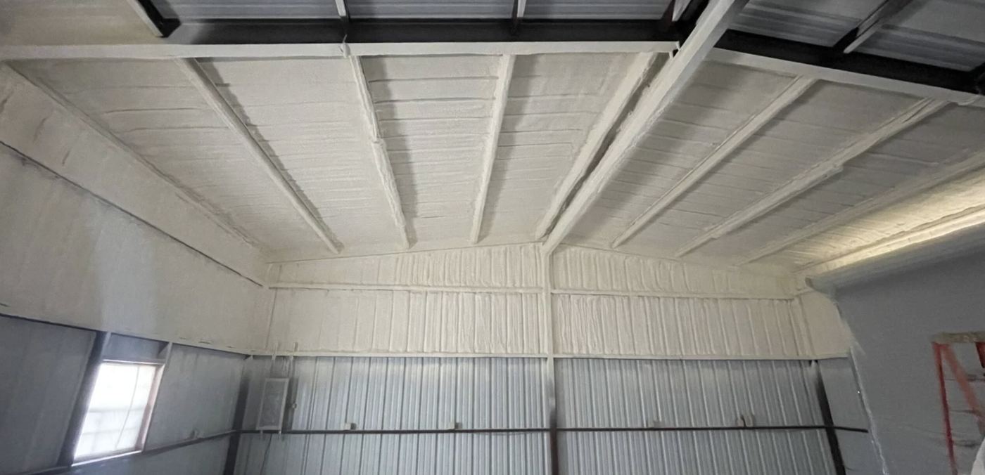 Spray foam insulation applied inside a metal commercial building